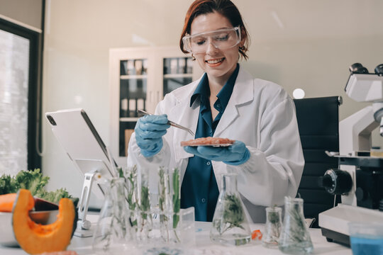 Scientists in lab coats work with plants in a modern lab, focusing on research and experimentation under bright, sterile conditions.