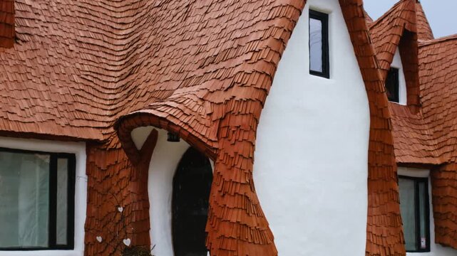 Clay castle of fairies with unique architectural design and wooden shingle roof in Romania.