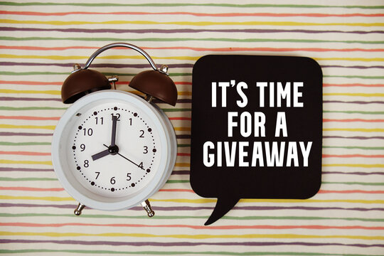 It's Time For A Giveaway text on speech bubble with alarm clock on colorful stripes background