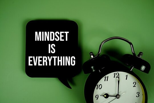 Mindset Is Everything text on speech bubble with alarm clock on green background