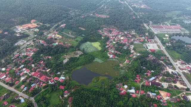 Aerial view reveals a vibrant village with red-roofed homes at Kampar, Perak
