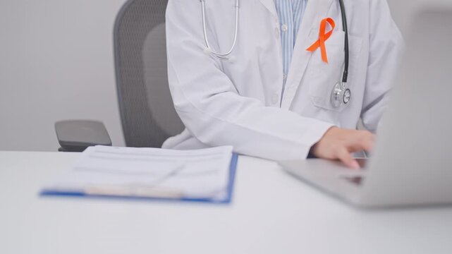 Professional doctor using laptop and writing notes for February World Cancer Day, September Leukemia, March Kidney, August Appendix, Multiple Sclerosis, November CRPS and COPD disease concept