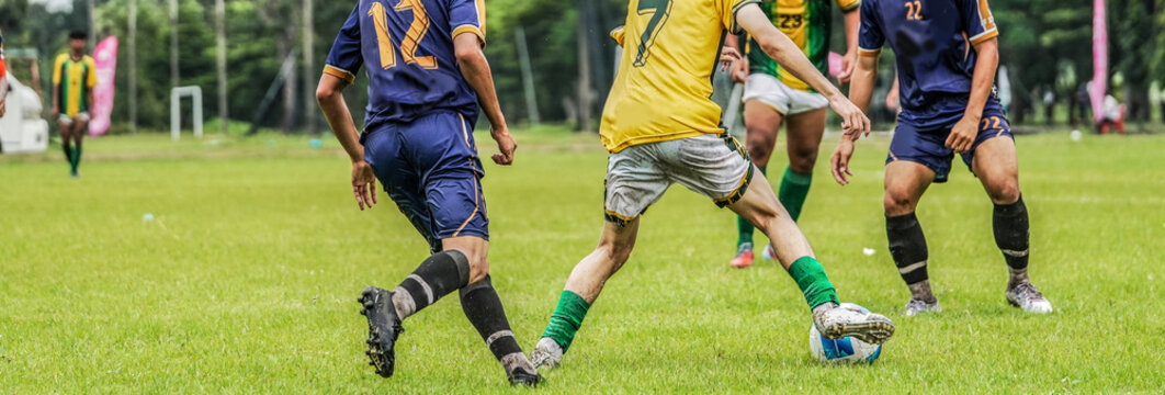 Soccer players competing for the ball during intense football ma