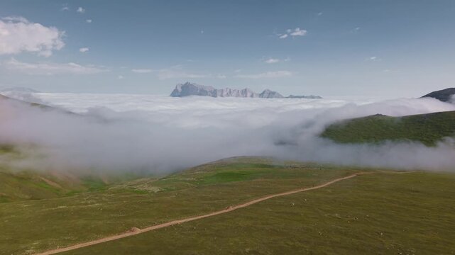 Aerial view of mountains above clouds with parallax movement across landscape