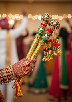 Traditional Indian Dandiya Sticks Held by Woman with Henna Mehndi and Bangles During Navratri Garba Celebration