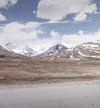 Rocky mountain slopes in the Pamir Mountains in Tajikistan, a minimalist landscape and rocky hills in sunny weather