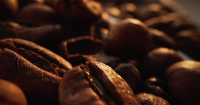 Slow motion close up of roasted coffee beans shifting on tabletop in studio setting.