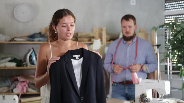 Disappointed customer reacting to defect in custom-made jacket