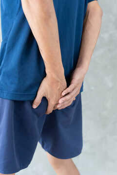 Man hand holding bottom because having abdominal pain and hemorrhoids, No sit health care, constipation, Anatomical, suffering from pain, abdominal, bowel problem, bloody diarrhea, cancer