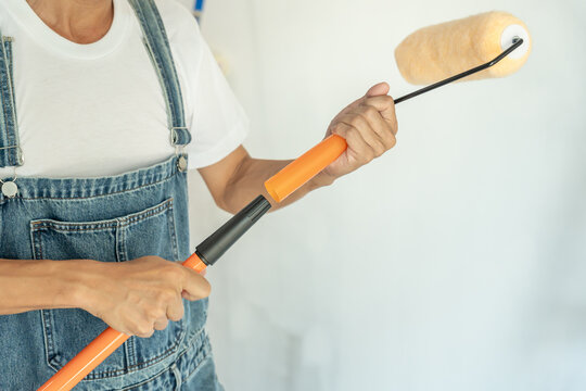 painter man prepare brush for products to restore and paint the wall, indoor the building site of a house, wall during painting, renovation, painting, contractor, Architect, construction worker