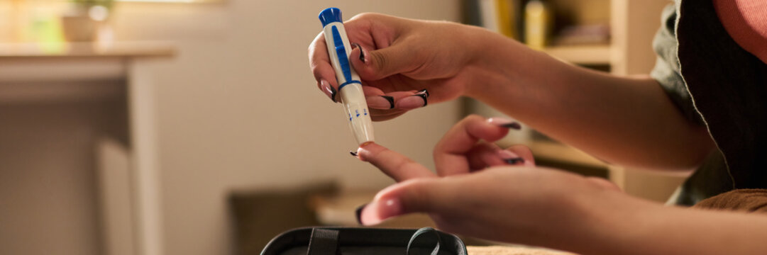 Header design of girl using lancing device to prick finger for blood glucose test. Image represents diabetes management, suitable for healthcare marketing