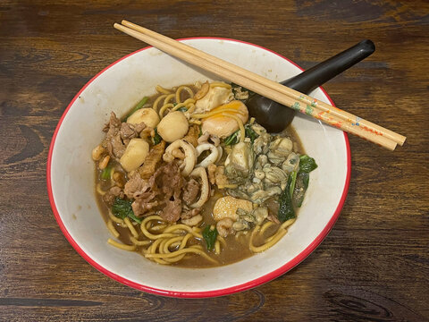 Phuket Hokkien Noodles is a famous local dish featuring thick egg noodles stir-fried in a rich, smoky seafood gravy. It delivers a deeply comforting flavor unique to Phuket Thailand 