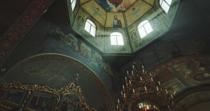 Ornate Chandelier Beneath Painted Vaulted Church Ceiling