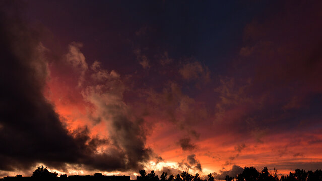 A spectacular dramatic sunset in early summer before a storm. Second view.