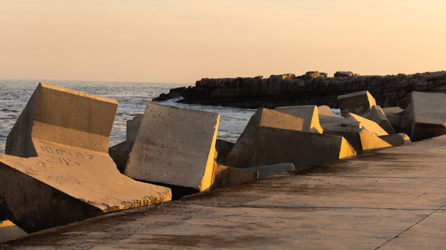 distinctive concrete cubist breakwater design, new Harbor, Hermanus, South Africa at sunset and dusk