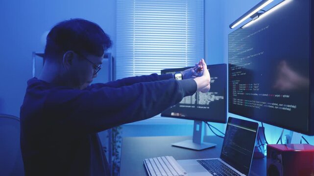 Asian Specialist Programmer Stretching After Late Night Coding Work. Take a Break Concept.