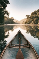 Point of view from wooden canoe floating on calm forest river at sunrise, peaceful outdoor adventure and nature exploration concepts © wilson