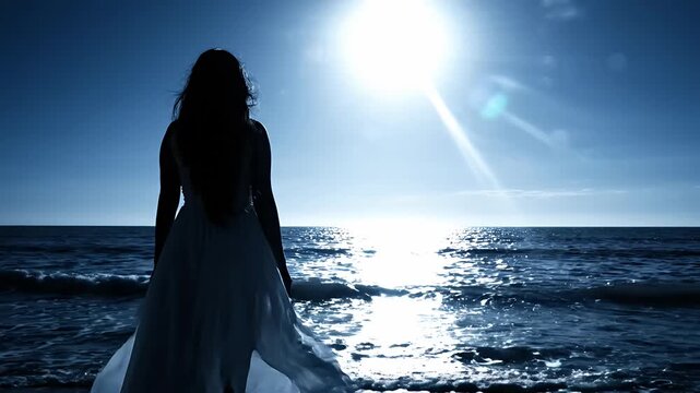 Silhouette of woman by ocean under bright moonlight.