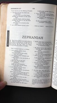 Kuala Lumpur, Malaysia - July 22nd, 2026: Opening to the book of Zephaniah of the Old Testament in the Holy Bible. New Revised Standard Version. Vertical video.