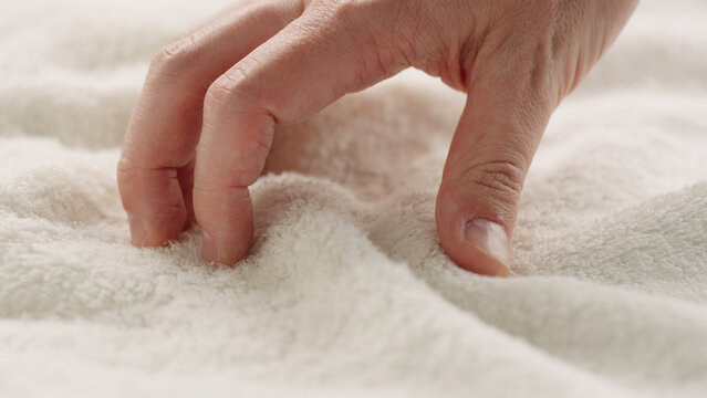 closeup shot of man touching white cotton terry towel