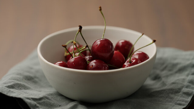 serving fresh cherries in white bowl