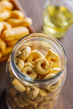 Crunchy Ring Snacks In Glass Jar On Wooden Table.  Savory Italian Taralli Pantry Closeup