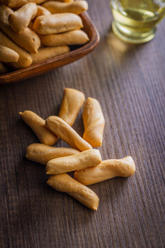 Crispy Breadsticks on Wooden Table With Bowl and Olive Oil for Snack or Appetizer