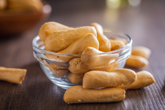 Crunchy Breadsticks In Glass Bowl On Wooden Table For Casual Snack And Entertaining