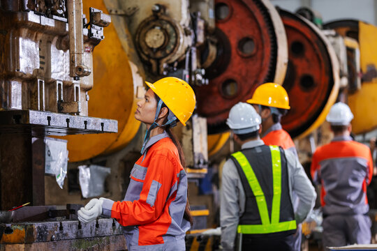 Female Factory Worker Operating Industrial Press Machine in Modern Manufacturing Plant