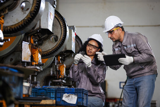 Production Supervisors Inspecting Precision Component with Digital Tablet in Modern Manufacturing Factory