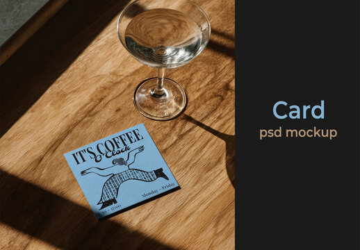 Coffee Card Mockup PSD On Wooden Table With Glass And Warm Sunlight