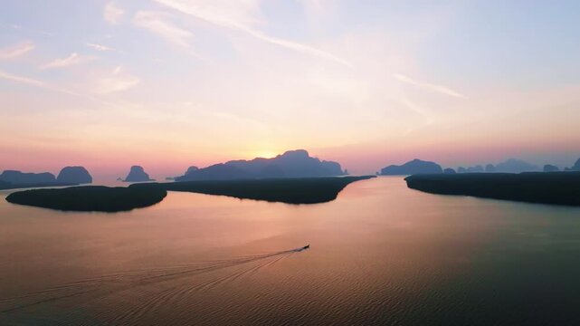 Colorful sunset or sunrise above the sea surface,Aerial view drone fly over open sea,Reflected sun beautiful light of nature on water surface,Sunset over ocean,Sea summer and travel vacation concept