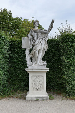 Baroque Statue Holding Scroll in the Gardens of Belvedere Palace, Vienna, Austria. 