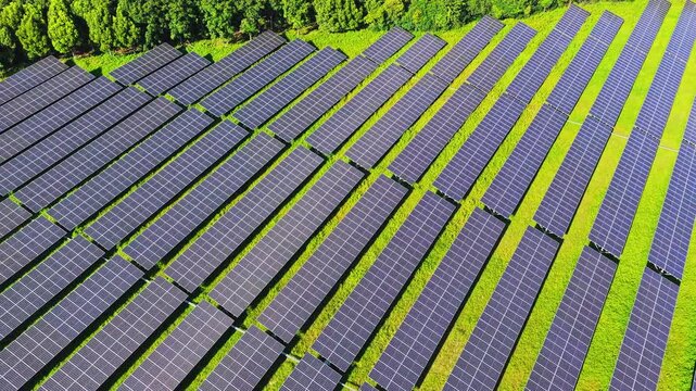 Top down drone view of a solar farm in green countryside