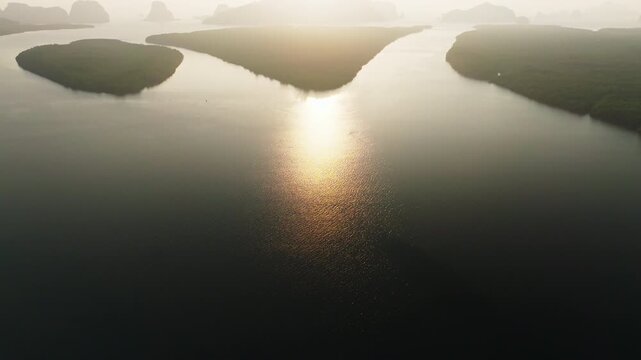 Colorful sunset or sunrise above the sea surface,Aerial view drone fly over open sea,Reflected sun beautiful light of nature on water surface,Sunset over ocean,Sea summer and travel vacation concept
