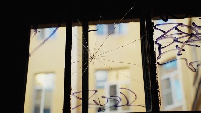 Broken window with security bars viewing courtyard