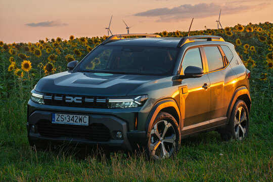 The third-generation Dacia Duster outdoors in a field of blooming sunflowers