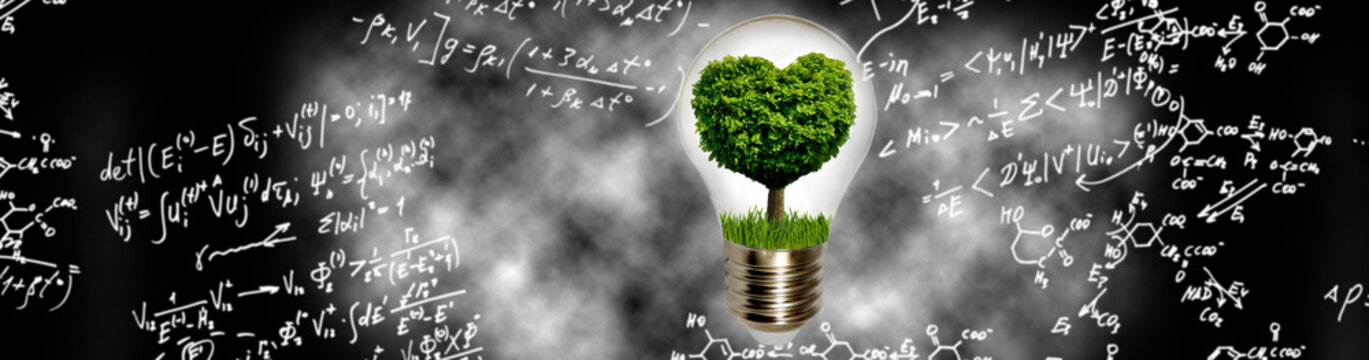 Light bulb with a tree inside shows the concept of green energy in a science background