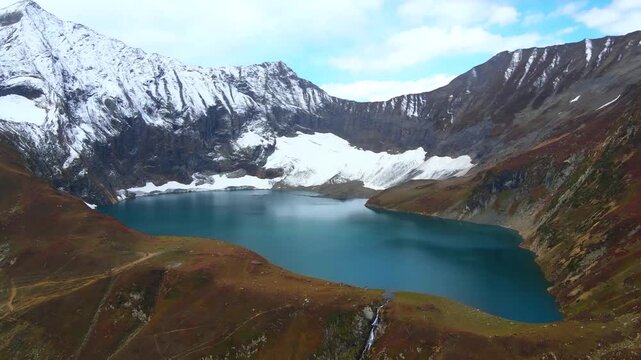 Ratti Gali Lake surrounded by high snowy mountain peaks