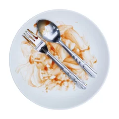 round white plate,fork and spoon stained with red sauce after finishing meal isolated on white. © eNJoy Istyle