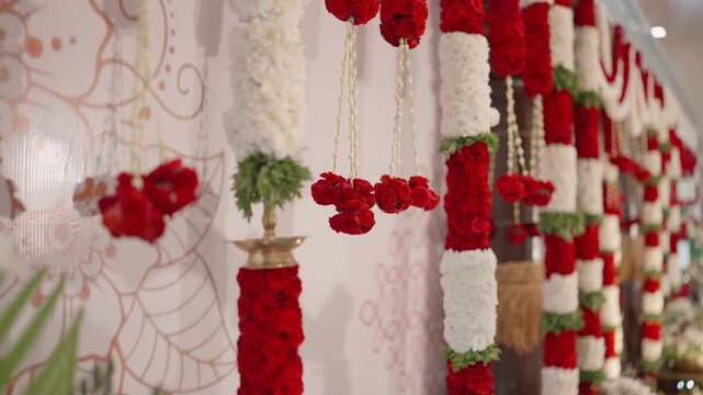 Shallow dolly focus on colourful hanging garland lace and bead decoration on venue stage in India