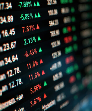 Stock market trading board with percentage changes and financial data display showing gains and losses