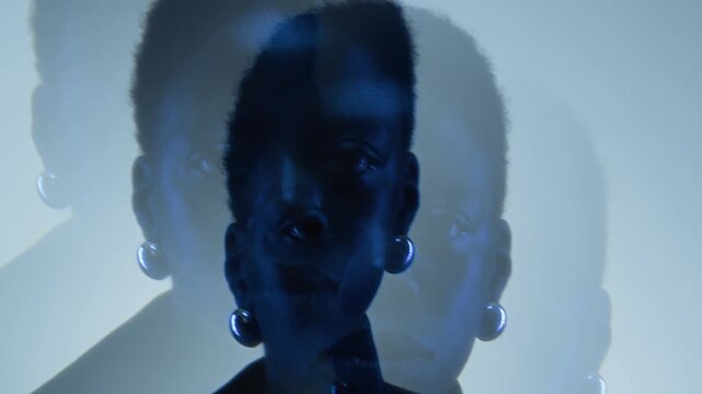 Portrait of African American young adult woman looking into camera with artistic prism overlay. Creative visual ideal for mental health awareness campaigns, psychology projects or music videos
