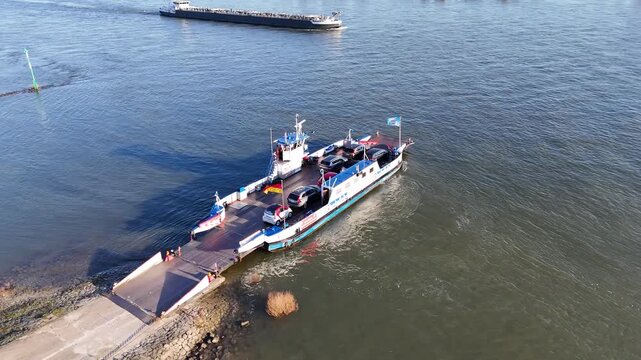 Drone looks down from above the ferry and climbs smoothly, keeping the vessel centered from a high top down perspective.
