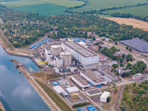 Aerial view of the CNPE de Fessenheim nuclear power plant, featuring reactor containment buildings and industrial facilities next to the Grand Canal d'Alsace in Fessenheim, Grand Est, France.