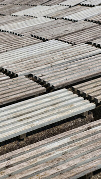 Weathered wood planks forming a repeating pattern of parallel lines and textured surfaces, reflecting time, decay, and the beauty of natural materials exposed to the elements