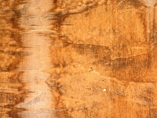 Fototapeta premium Close-up of rustic natural wood surface with rich brown grain patterns, knots, and irregular dark markings. Perfect organic background texture.