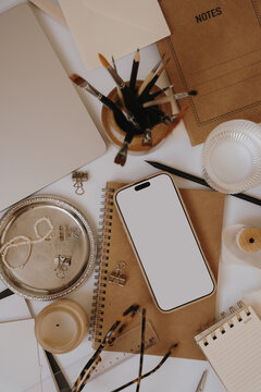 Smartphone Blank Screen Mockup On Kraft Notebook In Aesthetic Neutral Artist Workspace Setup