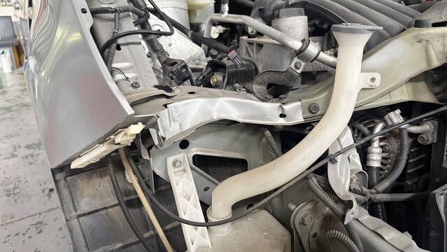 Front-end collision damage with disassembled engine compartment