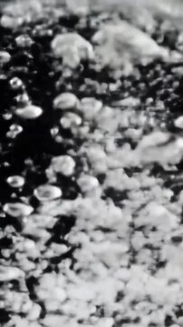 Boiling water with lots of bubbles in black and white